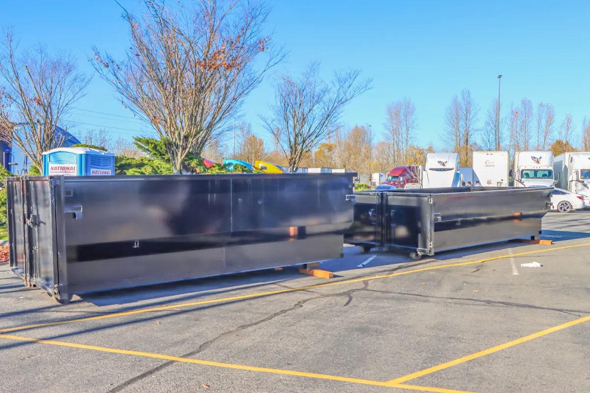 Professional dumpster rental service with roll-off container on residential driveway in South Holland